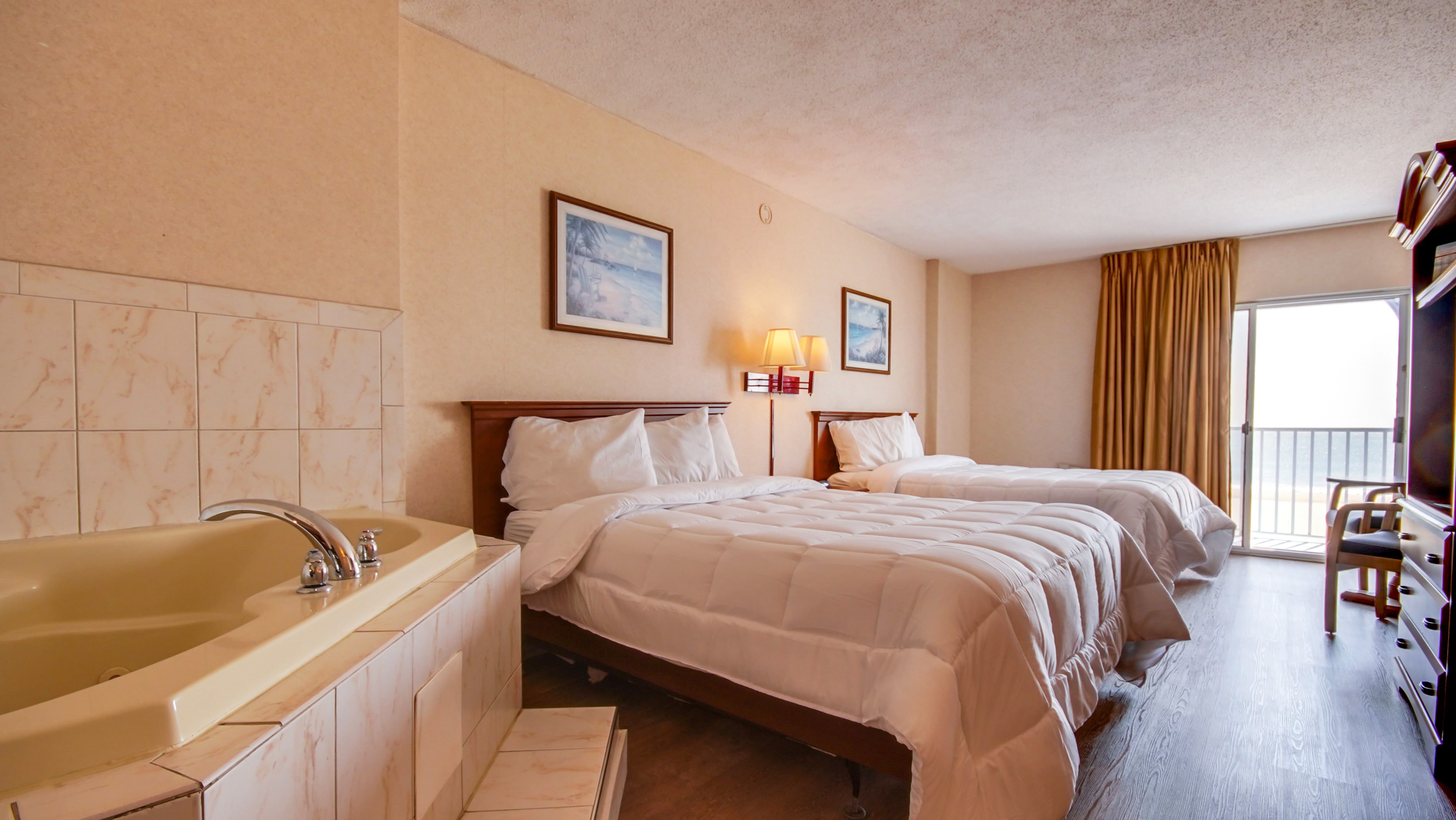 Two queen beds and jacuzzi in one room at the Ocean 1 Hotel & Suites in Ocean City, MD